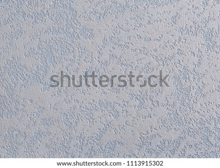 White plastered wall background with abstract pattern, close-up, macro.