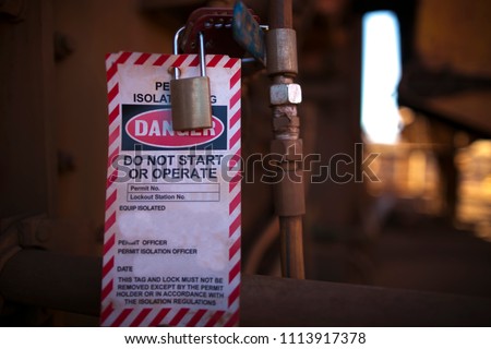 Danger permit isolation tag do not start or operate and locking to control life plant starting up, protection the risk of hazard at construction mine site, Perth western of Australia  Royalty-Free Stock Photo #1113917378