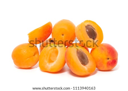View of tasty Armenian plums (Prunus armeniaca) over a white wooden background.