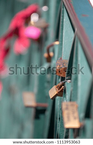 Close up view of several love locks left on a bridge by lovers.