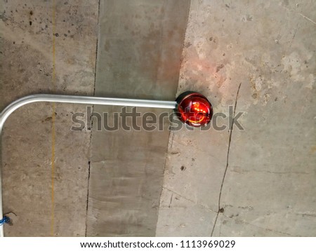 Red lamp sensor at indoor car parking area