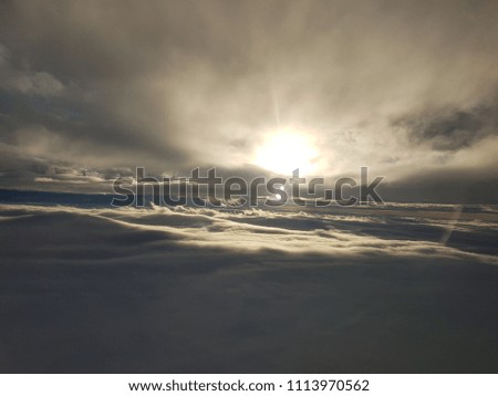 Clear blue sky with fluffy white clouds and airplane