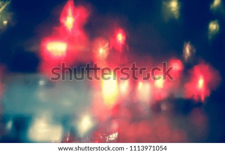 Abstract blurred Light traffic jam bokeh from inside a car view to outside road background while raining with rain drops on glass, night cityscape,cinematic photography vintage with film grain style.