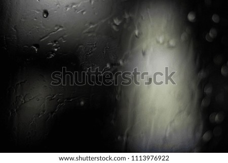 Drops Of Rain Water In Night Or Evening Street Lights On Blue Glass Background