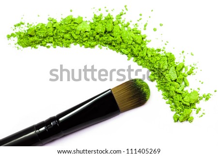 Professional make-up brush on green crushed eyeshadow