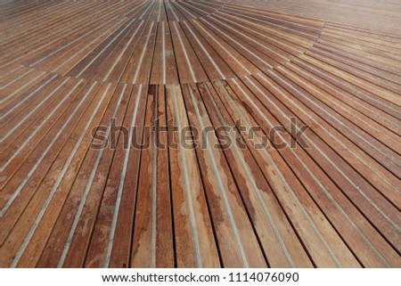 Inside view of a large wooden floor. Pattern of long brown planks. Perspective and graphic design with leading colored lines. Pathway in a french railway station. Abstract architectural image.  
