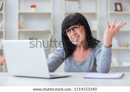 Senior woman struggling at computer