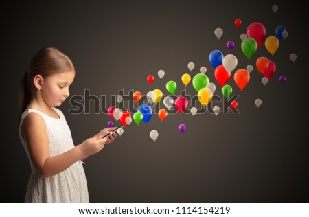Cute little girl using tablet with colourful balloons concept