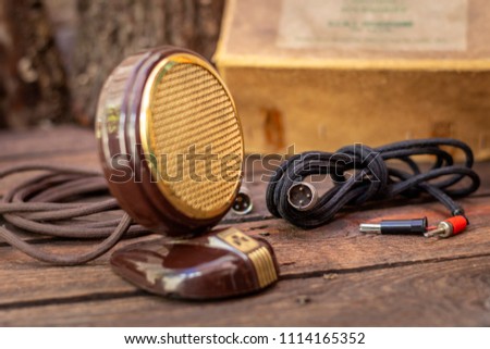 Close up shot of a antique 50s microphone with cables and box, vintage retro style media concept.