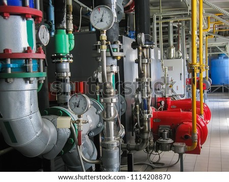Industrial steam boilers in the boiler room, and powerful turbine gas burner