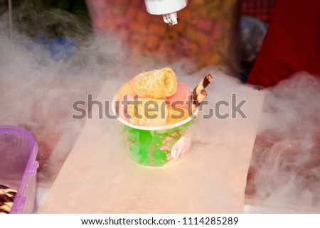 Trader in the market showing how to make the Dragon breath dessert or "Dragon Breath Balls" are Liquid Nitrogen-Infused Desserts