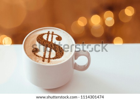 cup of cappuccino with a picture of a dollar