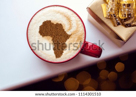 Cup of cappuccino with a picture of Africa