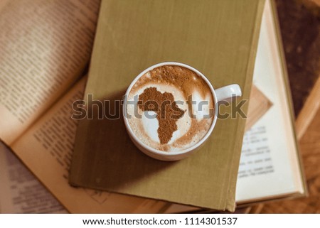 Cup of cappuccino with a picture of Africa