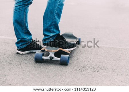 Close up of boy's feet and long board