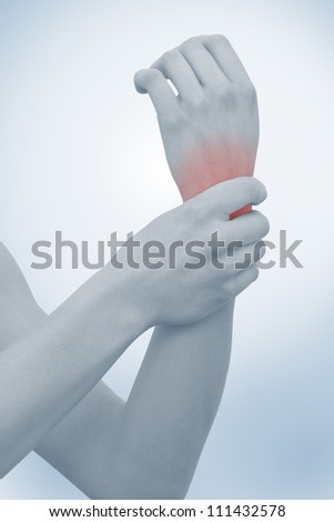 Acute pain in a woman wrist. Female holding hand to spot of wrist pain. Concept photo with Color Enhanced blue skin with read spot indicating location of the pain.