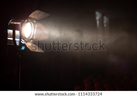 Studio spotlight using for background production film . silhouette blurred led lights with smoke in dark room . electric tools set for photography , video maker , cinematography Royalty-Free Stock Photo #1114333724