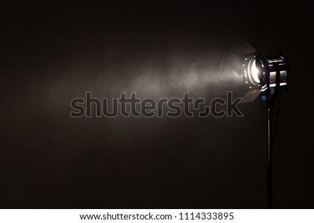 Studio spotlight using for background production film . silhouette blurred led lights with smoke in dark room . electric tools set for photography , video maker , cinematography Royalty-Free Stock Photo #1114333895