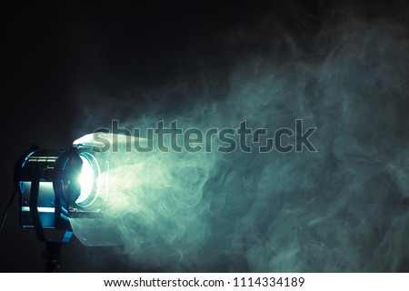 Studio spotlight using for background production film . silhouette blurred led lights with smoke in dark room . electric tools set for photography , video maker , cinematography Royalty-Free Stock Photo #1114334189