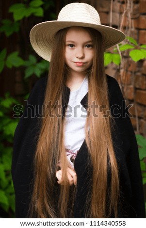portrait Fashion little girl in a hat  in Outdoor.