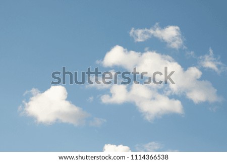 powerfully cumulus rain white clouds on a blue sky