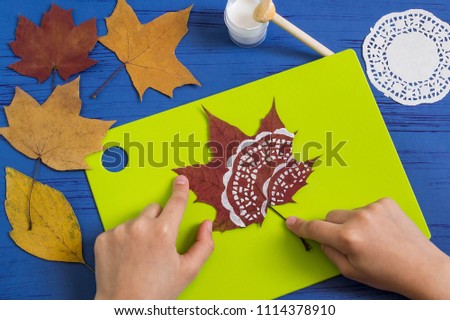 Hand-painted on dry autumn leaves by dint of paper lace napkin. Children's art project. DIY concept. Step by step photo instructions. Step 3. Dry drawing 