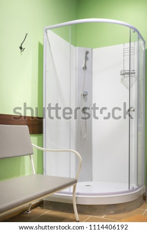 Shower cabin in the room with green walls