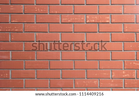 Close up photo of a red brick wall.