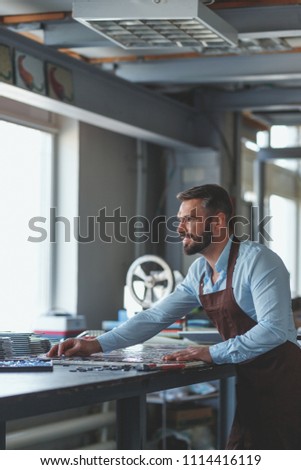 Working mature man in uniform in studio