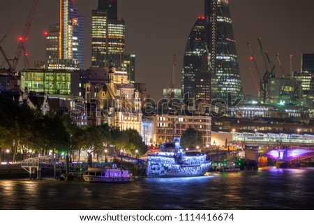 amazing london skyline and lights refelcted in river thames at night