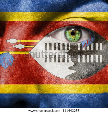 Flag painted on face with green eye to show Swaziland support