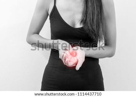 Pain or Massage in the palm. woman having pain in injured hand. hands suffering from working or accident or exercise. medical, check up and healthcare concept. image black and white ,red highlight 