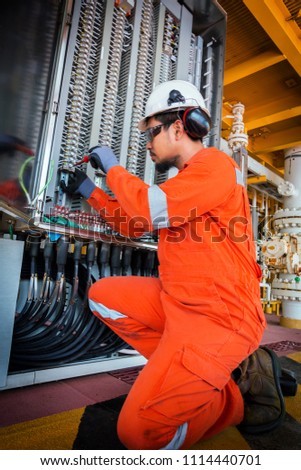 Electrical and instrument technician troubleshooting on programmable logic controller of oil and gas production system