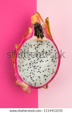 Dragon fruit on bright rose and pink background, pop art. Top view, flat lay, copy space. Fashion colors, layout design, tropical summer concept