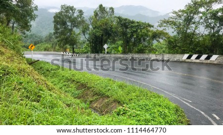 Road down hill at Thailand mountains, country road and mountain with Traffic Signs, Road with signs and mountain at country