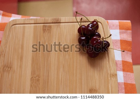 red ripe beautiful cherries with checkered background