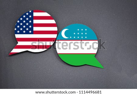 USA and Uzbekistan flags with two speech bubbles on dark gray background