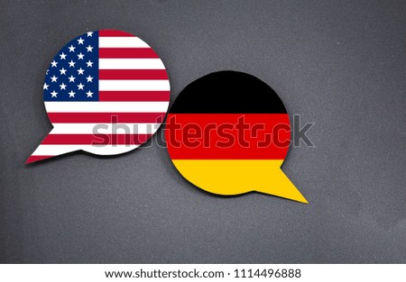 USA and Germany flags with two speech bubbles on dark gray background