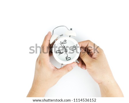 caucasian man hand adjusting the time of a Retro clock an vintage style, isolated on white background