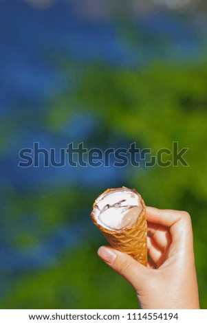 Ice cream cone, chocolate ice cream on blurred background, milk dessert on summer vacation, blank for designer, copy space, art
