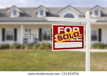 Red Sold For Sale Real Estate Sign in Front of House.