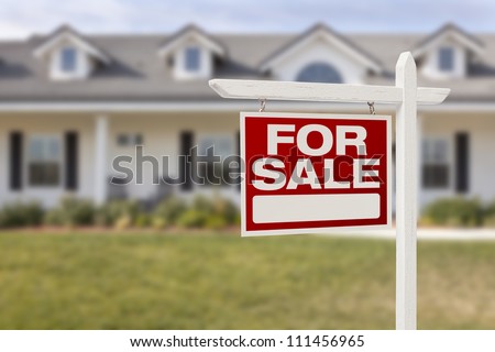 For Sale Real Estate Sign in Front of Beautiful New Home.
