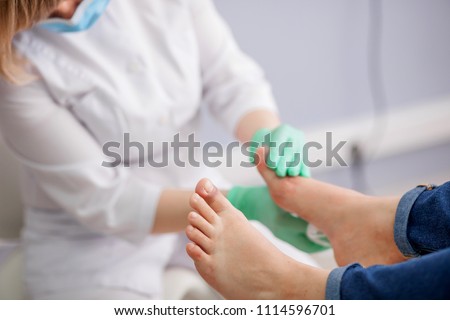 doctor, the podiatrist examines the foot Royalty-Free Stock Photo #1114596701