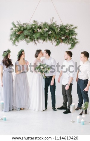 Full length portrait of newlywed couple and their friends at the wedding party