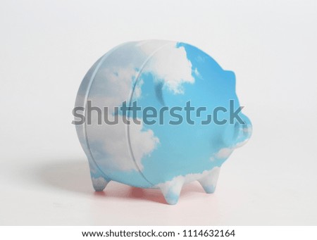 Piggy bank with blue sky with clouds isolated on white background