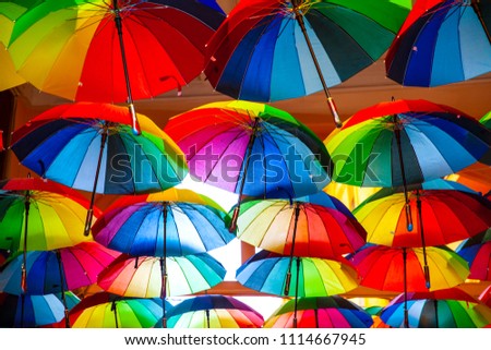 Rainbow gay pride protection symbol in hanging umbrellas 