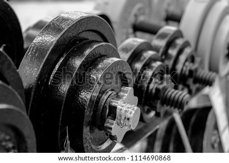 Rack with dumbbells. The concept of a healthy lifestyle. Sale of sports equipment. black and white.