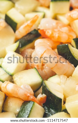 Cooking seafood mixtures of vegetables and shrimps in pan roasting