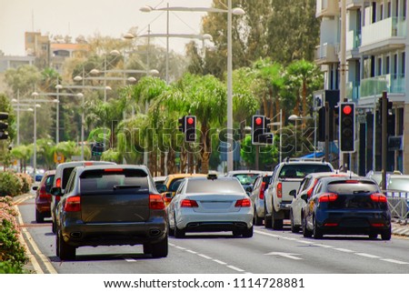 cars stopped at a red traffic light signal in the summer hot midday with a shallow depth of field Royalty-Free Stock Photo #1114728881