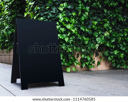 Blank Board stand mock up Black Signage shop Outdoor green garden 